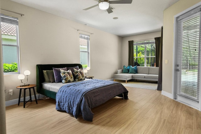 3307 Kentshire Blvd, Ocoee, FL 34761 - bedroom featuring access to exterior, light wood-style floors, and baseboards