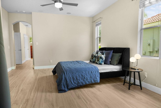 3307 Kentshire Blvd, Ocoee, FL 34761 - bedroom with arched walkways, wood finished floors, baseboards, and ceiling fan