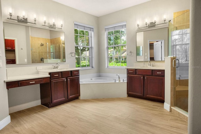 3307 Kentshire Blvd, Ocoee, FL 34761 - bathroom featuring a shower stall, a garden tub, two vanities, and wood finished floors