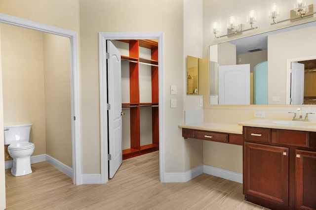 3307 Kentshire Blvd, Ocoee, FL 34761 - bathroom featuring wood finished floors, vanity, toilet, and baseboards