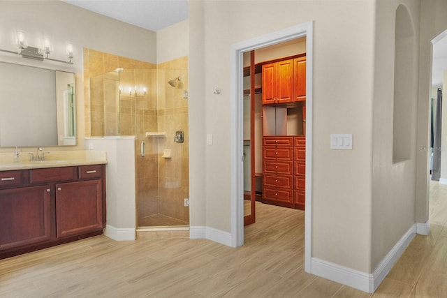 3307 Kentshire Blvd, Ocoee, FL 34761 - bathroom with a shower stall, vanity, wood finished floors, and baseboards