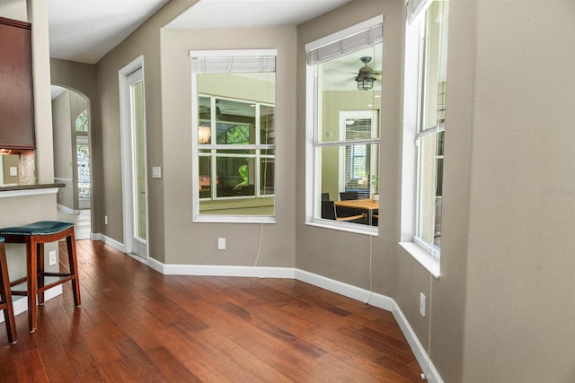 3307 Kentshire Blvd, Ocoee, FL 34761 - unfurnished dining area with dark wood-type flooring, arched walkways, baseboards, and ceiling fan