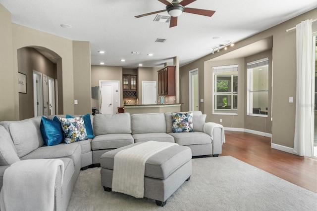 3307 Kentshire Blvd, Ocoee, FL 34761 - living area featuring arched walkways, ceiling fan, wood finished floors, baseboards, and recessed lighting