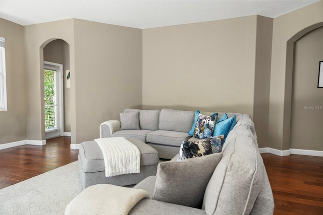 3307 Kentshire Blvd, Ocoee, FL 34761 - living area featuring arched walkways, hardwood / wood-style flooring, and baseboards