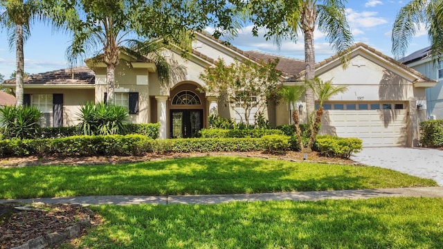 3307 Kentshire Blvd, Ocoee, FL 34761 - view of front of property with stucco siding, a garage, a front yard, and driveway
