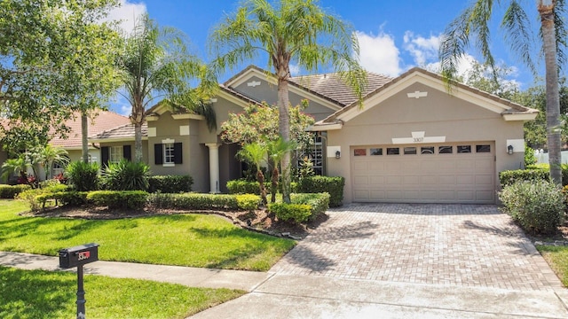 3307 Kentshire Blvd, Ocoee, FL 34761 - view of front of home with a garage, stucco siding, decorative driveway, and a front yard