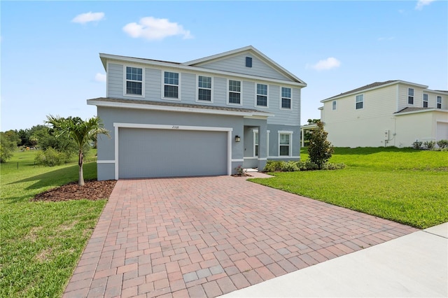 2168 Aibonito Cir, Clermont, FL 34711 - view of front of house with decorative driveway, a front lawn, an attached garage, and stucco siding