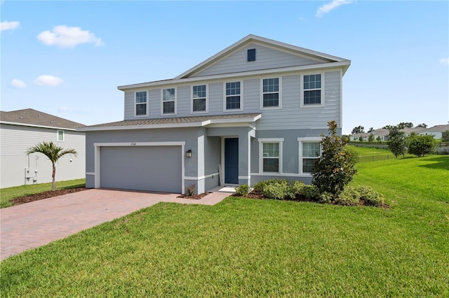 2168 Aibonito Cir, Clermont, FL 34711 - view of front of home featuring decorative driveway, an attached garage, stucco siding, and a shingled roof
