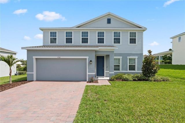 2168 Aibonito Cir, Clermont, FL 34711 - view of front of house with decorative driveway, a garage, a front yard, stucco siding, and roof with shingles