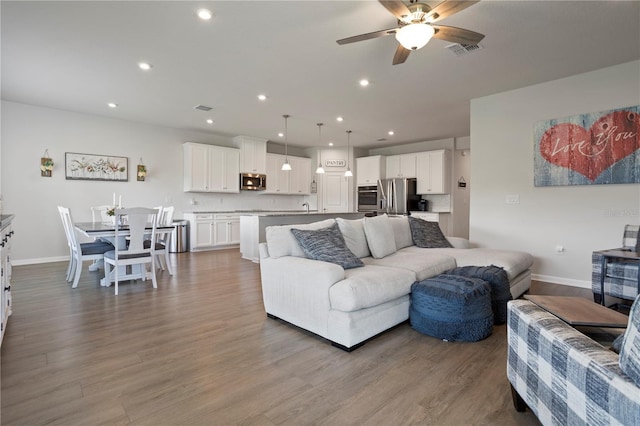 2168 Aibonito Cir, Clermont, FL 34711 - living area with a ceiling fan, wood finished floors, and recessed lighting