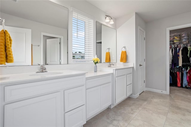 2168 Aibonito Cir, Clermont, FL 34711 - bathroom featuring double vanity and a walk in closet