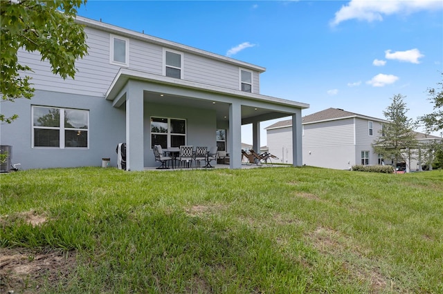 2168 Aibonito Cir, Clermont, FL 34711 - rear view of property featuring a patio area, a lawn, and stucco siding