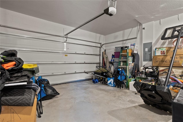 2168 Aibonito Cir, Clermont, FL 34711 - garage with electric panel, a garage door opener, and concrete block wall