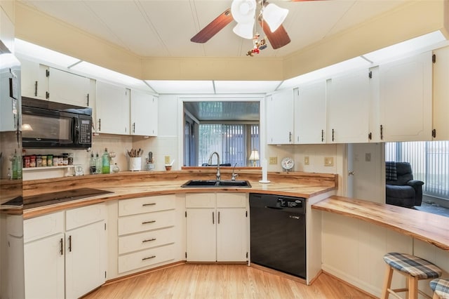 142 Florence Blvd, Debary, FL 32713 - kitchen with black appliances, wood counters, a sink, and healthy amount of natural light