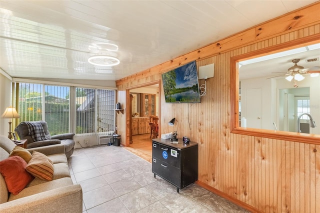 142 Florence Blvd, Debary, FL 32713 - living room featuring light tile patterned floors, wood walls, and ceiling fan