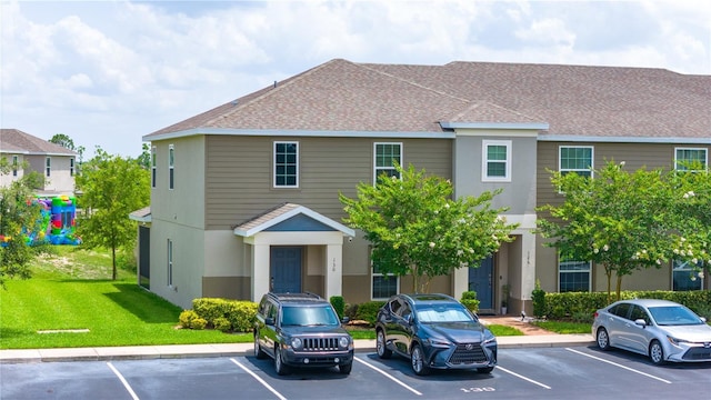 130 Claire Ln, Davenport, FL 33837 - view of front of house with uncovered parking, a front yard, and stucco siding