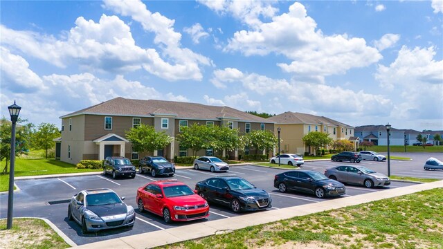 130 Claire Ln, Davenport, FL 33837 - uncovered parking lot featuring a residential view