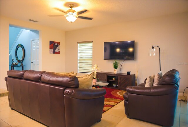 130 Claire Ln, Davenport, FL 33837 - living area with light tile patterned floors and ceiling fan