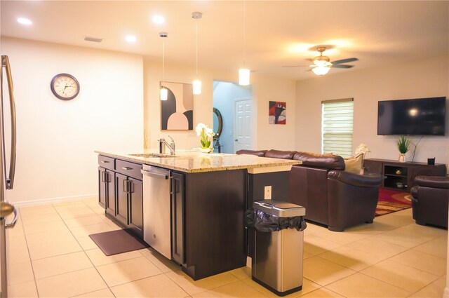 130 Claire Ln, Davenport, FL 33837 - kitchen with stainless steel dishwasher, open floor plan, a ceiling fan, light stone counters, and hanging light fixtures