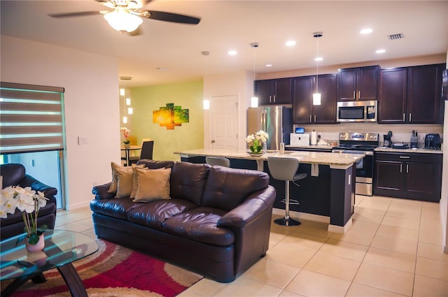 130 Claire Ln, Davenport, FL 33837 - living area with light tile patterned floors, ceiling fan, and recessed lighting