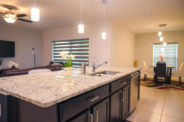 130 Claire Ln, Davenport, FL 33837 - kitchen with dishwasher, a ceiling fan, light tile patterned floors, light stone counters, and pendant lighting