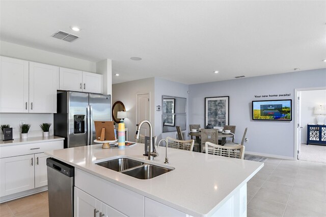 4240 Alice St, Edgewater, FL 32141 - kitchen featuring stainless steel appliances, a sink, a center island with sink, light countertops, and recessed lighting