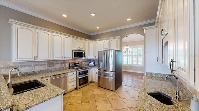 10809 Arrowtree Blvd, Clermont, FL 34715 - kitchen with stainless steel appliances, a sink, light stone counters, tasteful backsplash, and recessed lighting