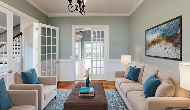 10809 Arrowtree Blvd, Clermont, FL 34715 - living room with a wainscoted wall, ornamental molding, wood finished floors, stairs, and a chandelier