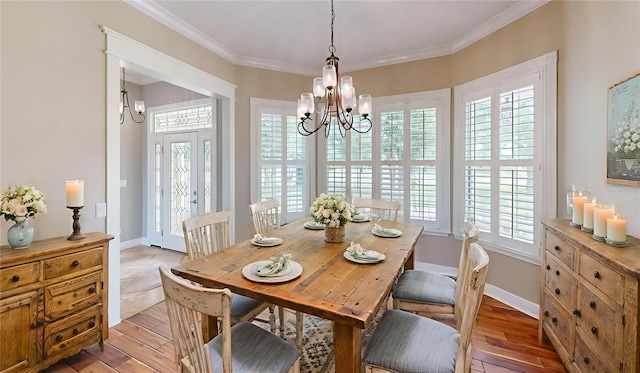 10809 Arrowtree Blvd, Clermont, FL 34715 - dining room with a chandelier, healthy amount of natural light, light wood-style floors, and crown molding