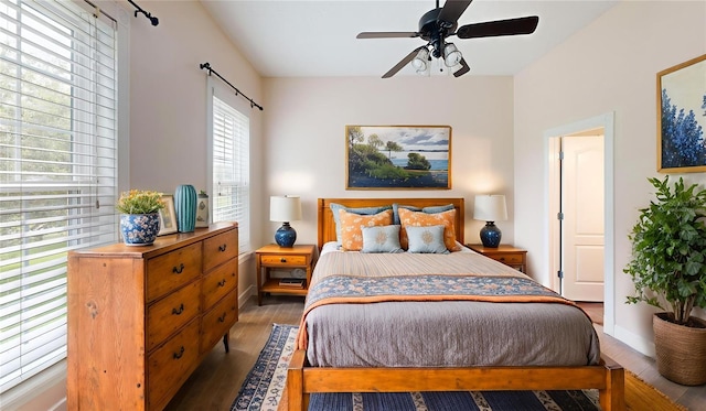 10809 Arrowtree Blvd, Clermont, FL 34715 - bedroom with wood finished floors, baseboards, and ceiling fan