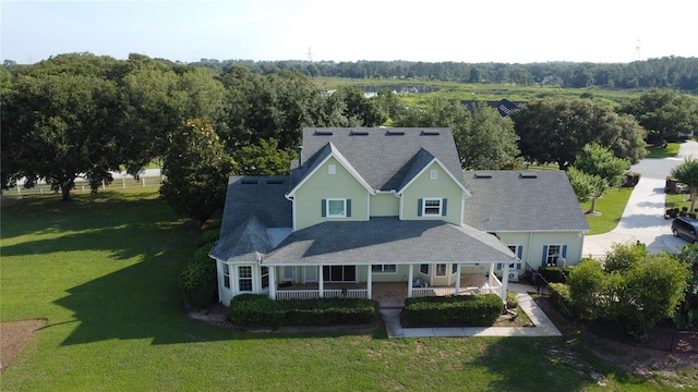 10809 Arrowtree Blvd, Clermont, FL 34715 - view of front facade with a porch, a front lawn, and roof with shingles