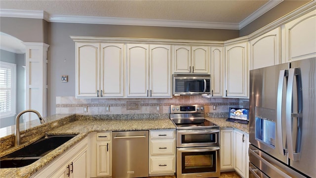 10809 Arrowtree Blvd, Clermont, FL 34715 - kitchen with stainless steel appliances, a sink, ornate columns, light stone countertops, and backsplash