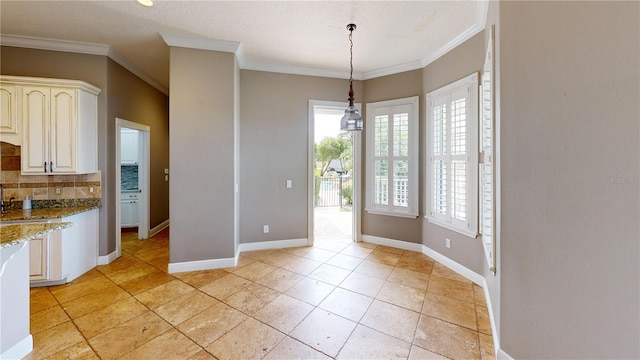 10809 Arrowtree Blvd, Clermont, FL 34715 - unfurnished dining area with ornamental molding, baseboards, and light tile patterned floors