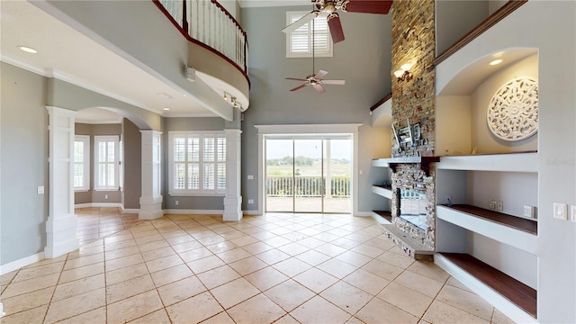10809 Arrowtree Blvd, Clermont, FL 34715 - living area with a ceiling fan, decorative columns, baseboards, a high ceiling, and crown molding