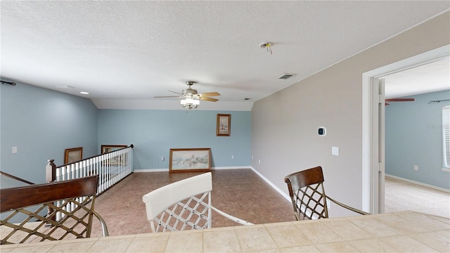 10809 Arrowtree Blvd, Clermont, FL 34715 - kitchen with ceiling fan, baseboards, tile patterned floors, and a textured ceiling