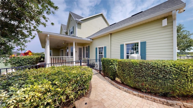 10809 Arrowtree Blvd, Clermont, FL 34715 - view of front of house featuring a ceiling fan and a shingled roof