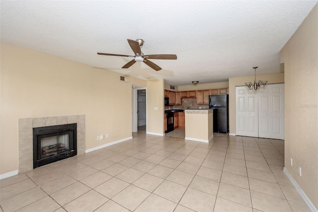 420 Forestway Cir Unit 206, Altamonte Springs, FL 32701 - unfurnished living room with a chandelier, ceiling fan, a textured ceiling, a tile fireplace, and light tile patterned flooring