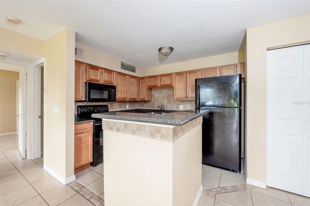 420 Forestway Cir Unit 206, Altamonte Springs, FL 32701 - kitchen with black appliances, light tile patterned flooring, tasteful backsplash, an island with sink, and a sink