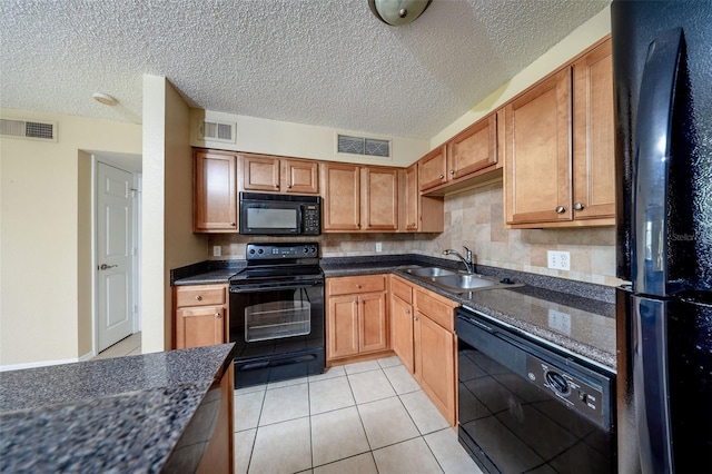 420 Forestway Cir Unit 206, Altamonte Springs, FL 32701 - kitchen featuring black appliances, a sink, a textured ceiling, light tile patterned floors, and dark stone counters