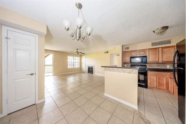 420 Forestway Cir Unit 206, Altamonte Springs, FL 32701 - kitchen featuring black appliances, dark countertops, light tile patterned flooring, a chandelier, and a textured ceiling