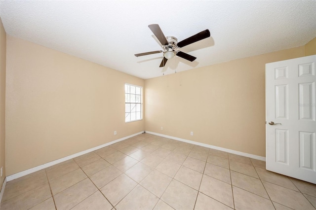 420 Forestway Cir Unit 206, Altamonte Springs, FL 32701 - empty room with a ceiling fan, light tile patterned flooring, baseboards, and a textured ceiling