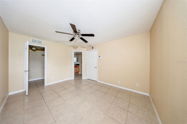 420 Forestway Cir Unit 206, Altamonte Springs, FL 32701 - unfurnished bedroom with a textured ceiling, light tile patterned floors, a ceiling fan, a closet, and a spacious closet