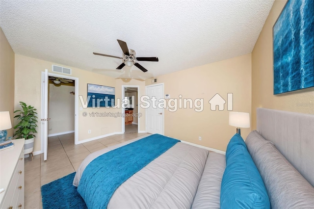 420 Forestway Cir Unit 206, Altamonte Springs, FL 32701 - bedroom featuring light tile patterned floors, a ceiling fan, a textured ceiling, and baseboards