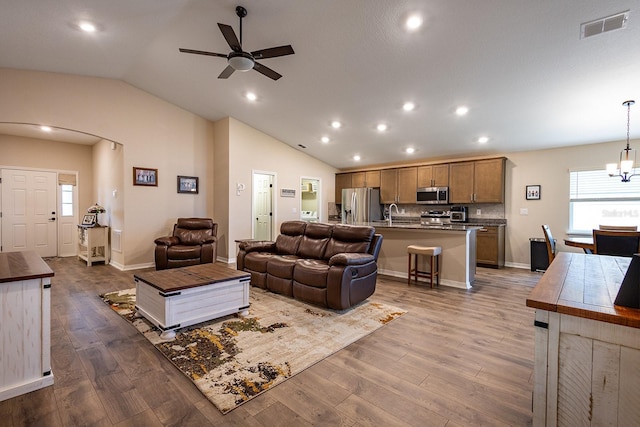 5416 Tessin Trl, Saint Cloud, FL 34771 - living area featuring vaulted ceiling, a ceiling fan, wood finished floors, recessed lighting, and a chandelier