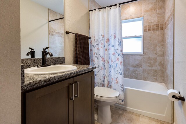 5416 Tessin Trl, Saint Cloud, FL 34771 - full bathroom with toilet, vanity, shower / bath combo with shower curtain, tile patterned flooring, and a textured wall