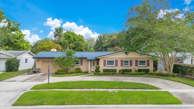 3405 Werber St, Orlando, FL 32806 - single story home featuring curved driveway, a chimney, a front yard, an attached garage, and metal roof