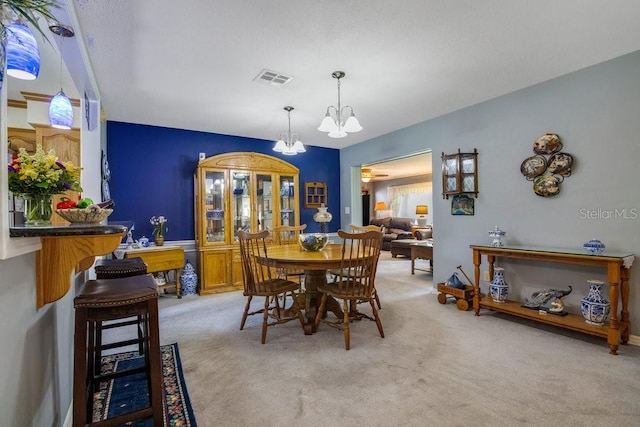 3405 Werber St, Orlando, FL 32806 - dining area with a chandelier and light carpet