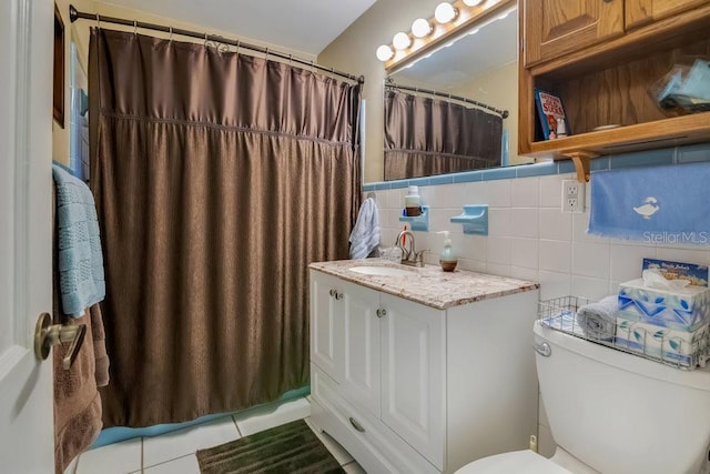3405 Werber St, Orlando, FL 32806 - full bathroom featuring toilet, vanity, tile patterned flooring, tile walls, and a shower with shower curtain