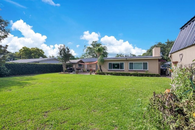 3405 Werber St, Orlando, FL 32806 - rear view of property featuring a lawn and a chimney