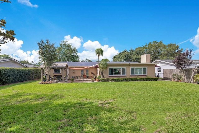 3405 Werber St, Orlando, FL 32806 - back of property featuring a patio, stucco siding, and a chimney